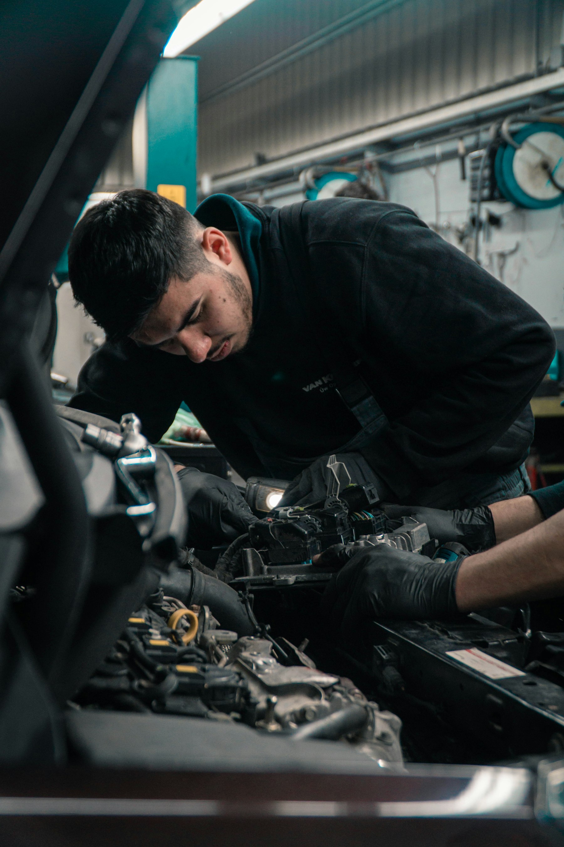 Mechanic servicing an engine in the Scott Superstore shop